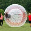 kids standing with a Knockerball brand human hamster ball